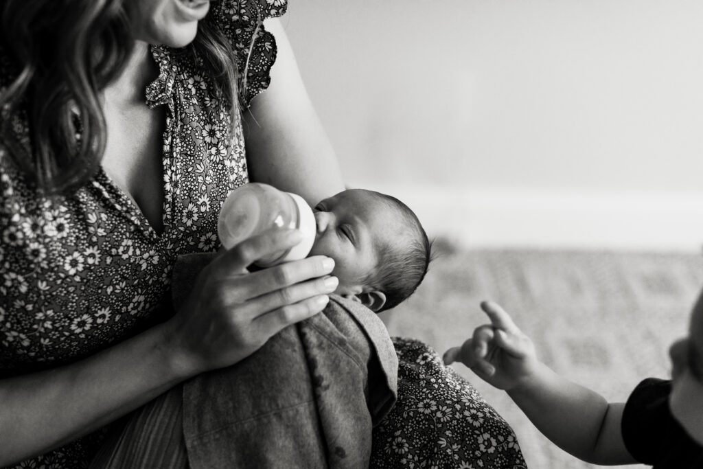 Bottle feeding is a great way to prepare your newborn for their Lifestyle Newborn Session with Emily Louise Photography in Fort Wayne Indiana